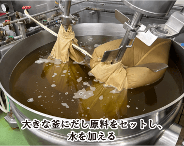 大きな釜にだし原料をセットし、水を加える